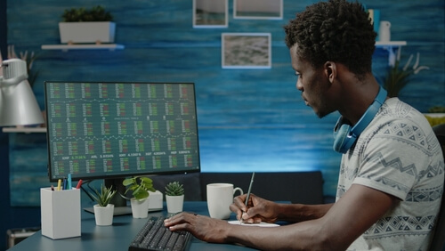 Person,Looking,At,Stock,Market,Trading,Data,On,Computer,Monitor.